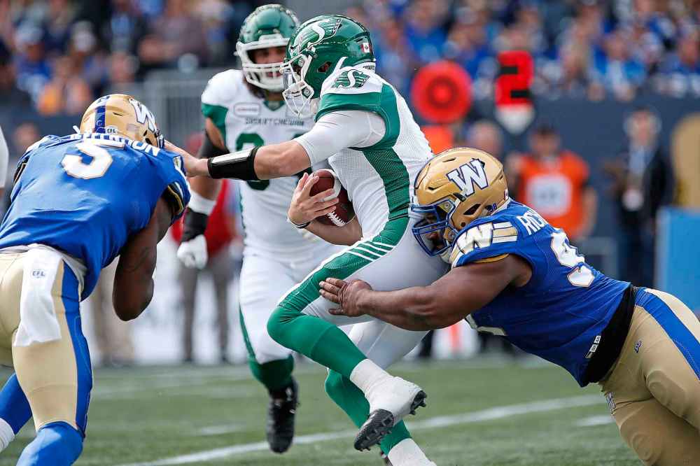 JOHN WOODS / THE CANADIAN PRESS
Winnipeg Blue Bomber' Steven Richardson (98) and Willie Jefferson (5) sack Saskatchewan Roughriders quarterback Cody Fajardo (7) during the first half of CFL action in Winnipeg Saturday, September 7, 2019.