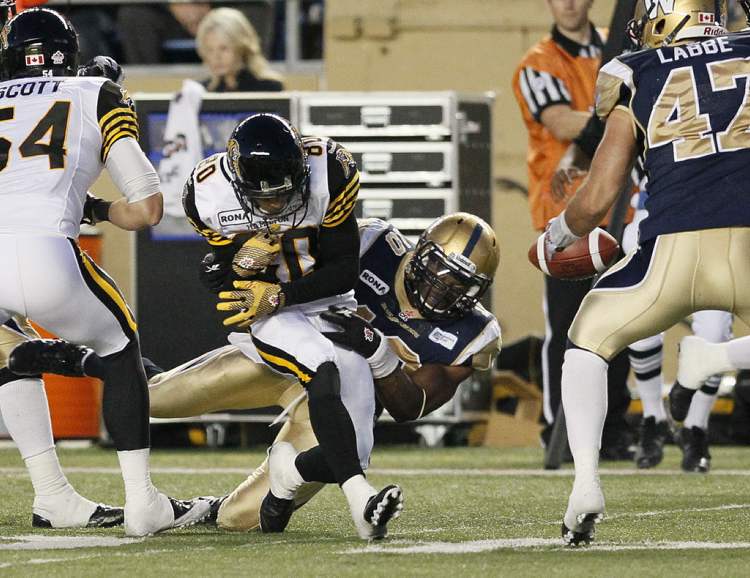 John Woods / The Canadian Press
Bombers' Henoc Muamba (10) forces the fumble as he takes down Hamilton Tiger-Cats' Chris Williams (80) during the second half.