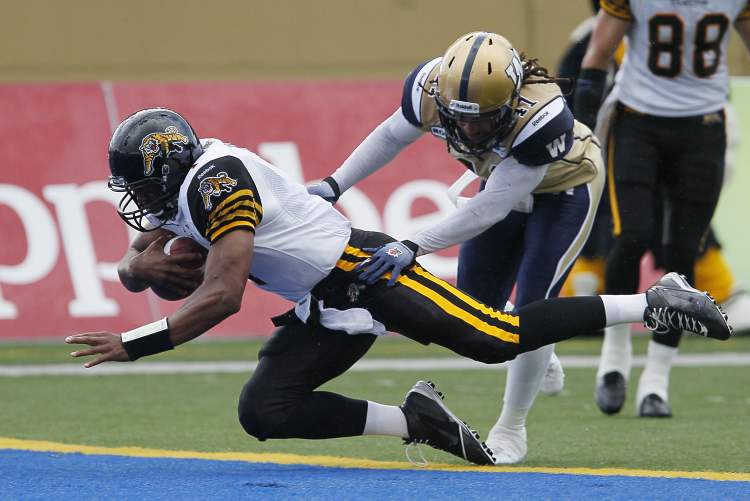 CP
Clint Kent tries to stop Hamilton Tiger-Cats' Henry Burris as dives in for touchdown Wednesday.