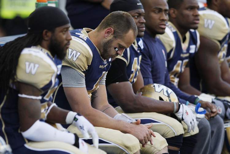 CP
A dejected Winnipeg Blue Bombers' quarterback Buck Pierce (4) sits on the bench during the second half of their CFL game against the Toronto Argonauts.
