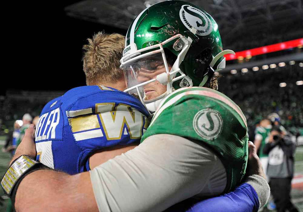 MARK TAYLOR / THE CANADIAN PRESS
Winnipeg Blue Bombers quarterback Chris Streveler, left, and Saskatchewan Roughriders quarterback Cody Fajardo embrace following the CFL West Division final.