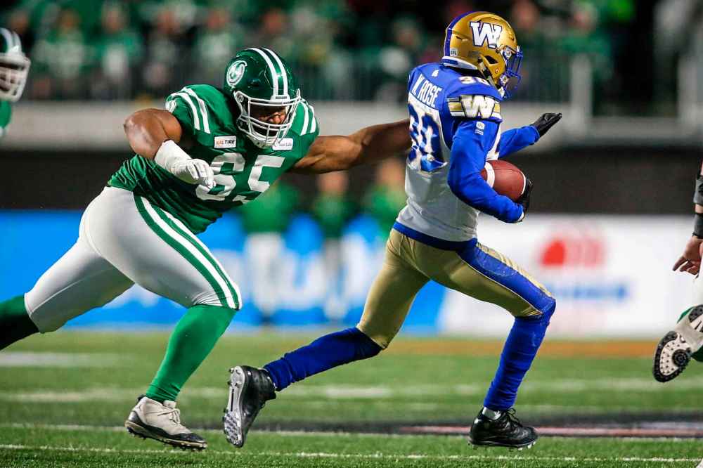 JEFF MCINTOSH / THE CANADIAN PRESS
Winnipeg Blue Bombers' Winston Rose, right, runs an interception as Saskatchewan Roughriders' Terran Vaughn tries to catch him during second half.