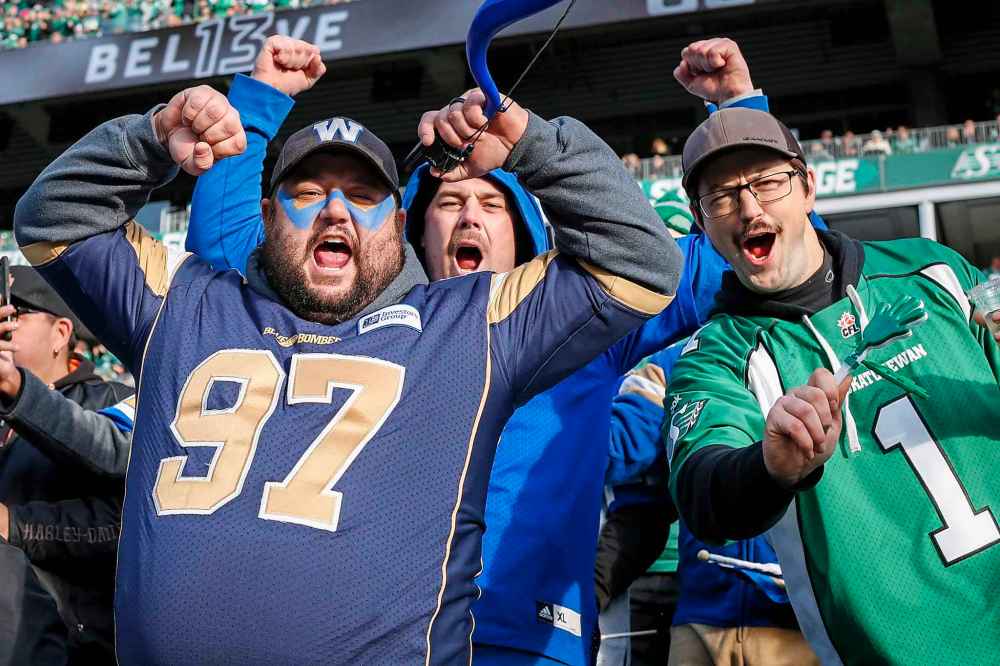 JEFF MCINTOSH / THE CANADIAN PRESS
Winnipeg Blue Bombers fans and a Saskatchewan Roughriders fan cheer their teams during CFL West Final.