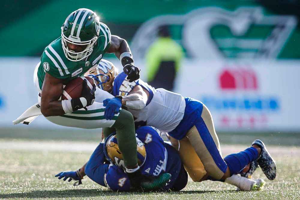 JEFF MCINTOSH / THE CANADIAN PRESS
Winnipeg Blue Bombers' Adam Bighill, centre, and Mike Smith, right, tackles Saskatchewan Roughriders' Cory Watson during CFL West Final football action in Regina, Sunday, Nov. 17, 2019.