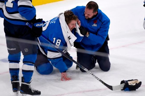 Winnipeg Jets' Bryan Little (18) is helped after getting hit in the head with the puck against the New Jersey Devils during third period NHL action in Winnipeg on Tuesday, Nov. 5, 2019. THE CANADIAN PRESS/Fred Greenslade
