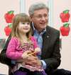 Adrian Wyld/ The Canadian Press
Prime Minister Stephen Harper holds Journey Benson, 3, at a school in Beaumont, Alta., Monday.