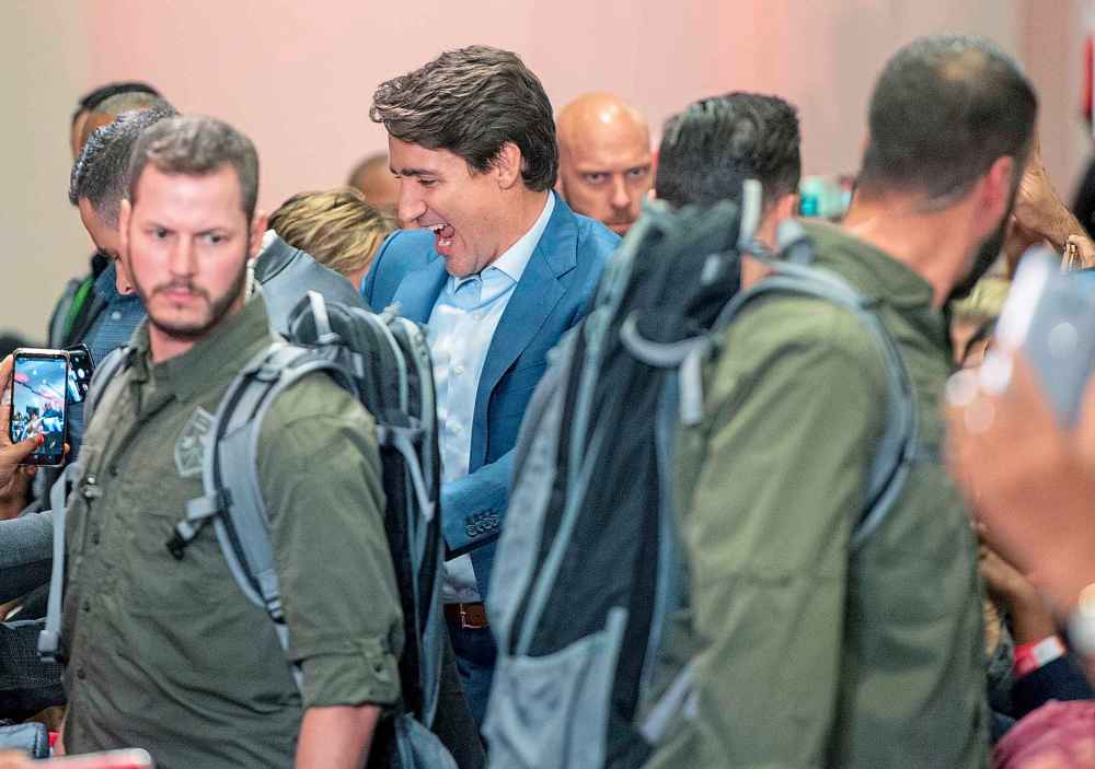 High profile security surrounds Liberal Leader Justin Trudeau as he arrives at a rally in Mississauga, Ont., Saturday, Oct. 12, 2019. The Rally was delayed for 90 minutes due to a security issue. THE CANADIAN PRESS/Frank Gunn