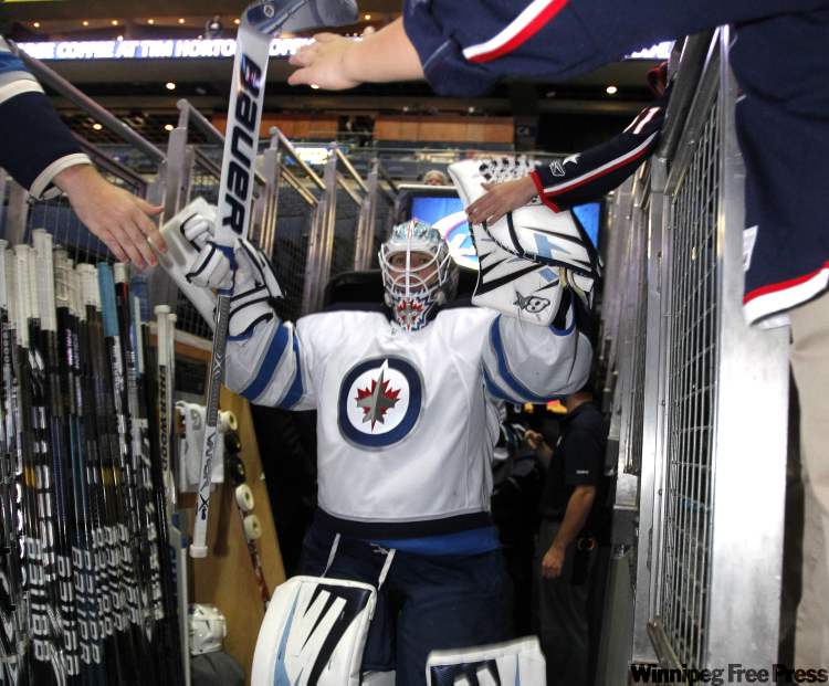 Boris Minkevich / Winnipeg Free Press
Chris Mason leads the Winnipeg Jets on to the ice at Nationwide Arena in Columbus, Ohio, Tuesday. The Jets take on the Columbus Blue Jackets in a split-squad pre-season game as the Jets return to the NHL after a lengthy absence.
