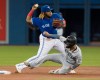 Seattle Mariners' Tim Lopes gets forced out at second base as Toronto Blue Jays' Vladimir Guerrero Jr. turns the double play during first inning American League MLB baseball action in Toronto, Saturday, Aug. 17, 2019. THE CANADIAN PRESS/Fred Thornhill