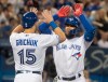 Toronto Blue Jays' Teoscar Hernandez, right, high fives with teammate Randal Grichuk after hitting a two-run home run against the Boston Red Sox in the fifth inning of their American League MLB baseball game in Toronto on Wednesday, September 11, 2019. THE CANADIAN PRESS/Fred Thornhill