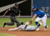 Tampa Bay Rays' Kevin Kiermaier slides in safely with a double as Toronto Blue Jays' Freddy Galvis misses the tag in the sixth inning of their American League MLB baseball game in Toronto Friday April 12, 2019. THE CANADIAN PRESS/Fred Thornhill