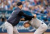 New York Yankees manager Aaron Boone holds player Brett Gardner back from getting at home plate umpire Chris Segal after a called third strike in the fourth inning of their American League MLB baseball game against the Blue Jays in Toronto Friday August 9, 2019. THE CANADIAN PRESS/Fred Thornhill