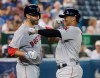 Boston Red Sox's Rafael Devers celebrates his two-run home run against the Toronto Blue Jays with teammate J.D. Martinez in the eighth inning of their American League MLB baseball game in Toronto, Tuesday, July 2, 2019. THE CANADIAN PRESS/Fred Thornhill