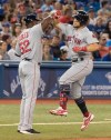 Boston Red Sox' Michael Chavis celebrates with third base coach Carlos Pebles after hitting a three run home run during sixth inning American League MLB baseball action against the Toronto Blue Jays, in Toronto on Thursday, July 4, 2019. THE CANADIAN PRESS/Fred Thornhill