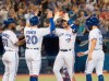 Toronto Blue Jays' Brandon Drury is met by teammates at home plate after hitting a grand slam during fourth inning American League MLB baseball action against the Texas Rangers, in Toronto, Monday, Aug. 12, 2019. THE CANADIAN PRESS/Fred Thornhill