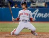 Boston Red Sox' Mookie Betts drops to his knees after being backed off the plate by an inside pitch in the seventh inning of their American League MLB baseball game against the Toronto Blue Jays in Toronto on Tuesday, September 10, 2019. THE CANADIAN PRESS/Fred Thornhill