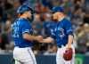 Toronto Blue Jays catcher Luke Maile, left, shakes hands with pitcher Ken Giles after they defeated the Baltimore Orioles in their American League MLB baseball game in Toronto on Wednesday, September 25, 2019. THE CANADIAN PRESS/Fred Thornhill