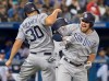 San Diego Padres' Hunter Renfroe celebrates with teammate Eric Hosmer after he hit a three run home run against the Toronto Blue Jays in the eighth inning of their Interleague MLB baseball game in Toronto Friday May 24, 2019. THE CANADIAN PRESS/Fred Thornhill