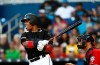 Miami Marlins' Starlin Castro (13) hits a double during the first inning of a baseball game against the Washington Nationals on Saturday, April 20, 2019, in Miami. (AP Photo/Brynn Anderson)
