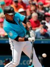 Miami Marlins' Starlin Castro (13) hits a foul ball in the third inning during an exhibition spring training baseball game against the St. Louis Cardinals on Wednesday, March 13, 2019, in Jupiter, Fla. (AP Photo/Brynn Anderson)