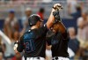Miami Marlins' Curtis Granderson celebrates a two-run home run with Caleb Smith (31) during the third inning of the team's baseball game against the New York Mets on Friday, July 12, 2019, in Miami. (AP Photo/Brynn Anderson)