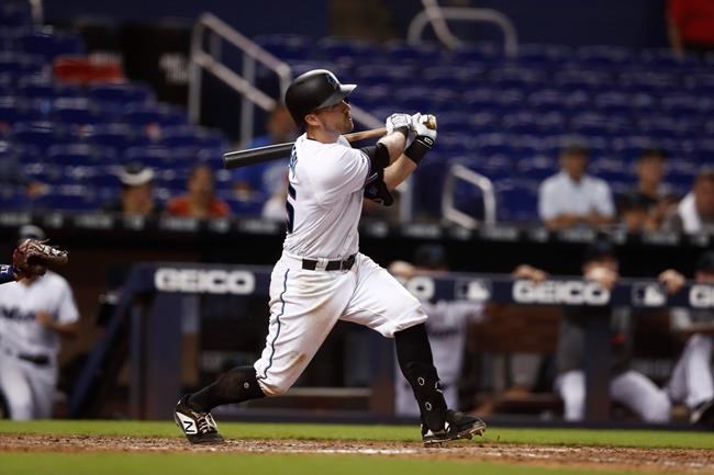 Miami Marlins' Jon Berti (55) hits a double during the ninth inning of a baseball game against the Minnesota Twins on Thursday, Aug. 1, 2019, in Miami. (AP Photo/Brynn Anderson)