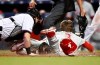 Miami Marlins catcher Chad Wallach, left, tags out Philadelphia Phillies' Bryce Harper (3) at home plate during the sixth inning of a baseball game Sunday, April 14, 2019, in Miami. (AP Photo/Brynn Anderson)