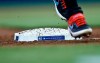 Miami Marlins' Starlin Castro runs past a commemorative third base bearing No. 42 in honor of Jackie Robinson Day during the first inning of a baseball game against the Chicago Cubs, Monday, April 15, 2019, in Miami. (AP Photo/Brynn Anderson)