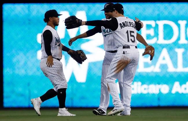 Miami Marlins' Harold Ramirez, left, Yadiel Rivera, center, and Brian Anderson, right, celebrate their win over the Arizona Diamondbacks in a baseball game on Sunday, July 28, 2019, in Miami. (AP Photo/Brynn Anderson)