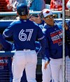 Toronto Blue Jays' Cavan Biggio (67) shakes hands with manager Charlie Montoya after Biggio hit a home run off Philadelphia Phillies starting pitcher Vince Valasquez during the second inning of a spring training baseball game Wednesday, March 6, 2019, in Dunedin, Fla. (AP Photo/Chris O'Meara)