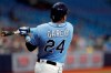 Tampa Bay Rays' Avisail Garcia watches his two-run double off Detroit Tigers starting pitcher Matt Moore during the first inning of a spring training baseball game Tuesday, March 26, 2019, in St. Petersburg, Fla. Rays' Yandy Diaz and Kevin Kiermaier scored. (AP Photo/Chris O'Meara)