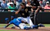 Toronto Blue Jays' JD Davis (1) slides safely into third base as the ball skips away from Pittsburgh Pirates' Jung Ho Kang during the fourth inning of a spring training baseball game Friday, March 8, 2019, in Bradenton, Fla. Davis advanced on a single by Eric Sogard. (AP Photo/Chris O'Meara)