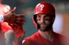 Philadelphia Phillies' Bryce Harper high-fives teammates after being taken out during the third inning of a spring training baseball game against the Toronto Blue Jays, Saturday, March 9, 2019, in Clearwater, Fla. (AP Photo/Chris O'Meara)
