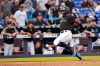 Miami Marlins' Miguel Rojas slides into home to score during the fourth inning of the team's baseball game against the Colorado Rockies in Miami on Saturday, March 30, 2019. (AP Photo/Gaston De Cardenas)