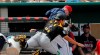 Pittsburgh Pirates catcher Steven Baron falls into the Minnesota Twins dugout as he catches a pop foul off the bat of Mitch Garver, in the first inning of their spring training baseball game in Fort Myers, Fla., Tuesday, Feb. 26, 2019. (AP Photo/Gerald Herbert)