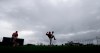 Boston Red Sox relief pitcher Brandon Workman, center, warms up in the rain as pitchers and catchers report for their first workout at their spring training baseball facility in Ft. Myers, Fla., Wednesday, Feb. 13, 2019. (AP Photo/Gerald Herbert)