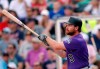 Colorado Rockies second baseman Daniel Murphy (9) follows through on a two-run home run in the first inning of a spring training baseball game against the Minnesota Twins Tuesday, March 26, 2019, in Fort Myers, Fla. (AP Photo/John Bazemore)