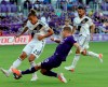 Orlando City's Chris Mueller (9) takes a shot against LA Galaxy's Rolf Feltscher (25) during the first half of an MLS soccer match Friday, May 24, 2019, in Orlando, Fla. (AP Photo/John Raoux)