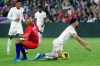 United States midfielder John Brooks (5) and Canada forward Lucas Cavallini, right, fall after they collided while going for the ball during the first half of a CONCACAF Nations League soccer match Friday, Nov. 15, 2019, in Orlando, Fla. (AP Photo/John Raoux)