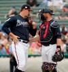 Atlanta Braves catcher Brian McCann, right, talks with pitcher Patrick Weigel, left, between innings during a spring baseball exhibition game against the New York Mets, Tuesday, Feb. 26, 2019, in Kissimmee, Fla. (AP Photo/John Raoux)
