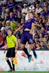 Orlando City's Kyle Smith (24) moves to control a header in front of Atlanta United's Justin Meram during the second half of an MLS soccer match Friday, Aug. 23, 2019, in Orlando, Fla. (AP Photo/John Raoux)