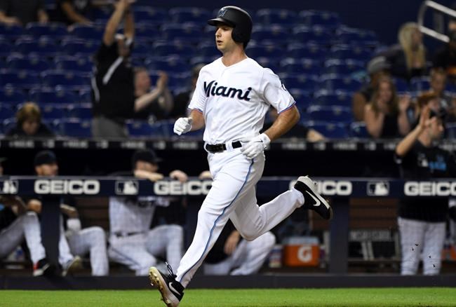 Miami Marlins' Trevor Richards heads home to score during the third of the team's baseball game against the Washington Nationals, Wednesday, June 26, 2019, in Miami. (AP Photo/Jim Rassol)