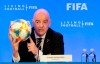 FIFA President Gianni Infantino holds a soccer ball as he speaks during a press conference after the FIFA Council Meeting, Friday, March 15, 2019, in Miami. The council approved working with Qatar to explore expanding the 2022 World Cup to 48 teams by adding at least one more country in the Persian Gulf to host matches. (AP Photo/Luis M. Alvarez)