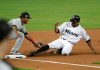 Miami Marlins' Curtis Granderson, right, is tagged out at third by Cleveland Indians third baseman Jose Ramirez during the first inning of a baseball game Wednesday, May 1, 2019, in Miami. (AP Photo/Lynne Sladky)