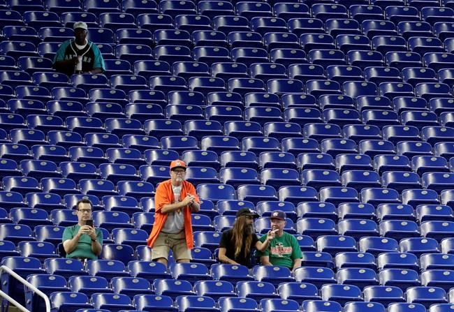 Fans watch a baseball game between the Miami Marlins and San Francisco Giants, Thursday, May 30, 2019, in Miami. Major League Baseball's average attendance of 26,854 is 1.4% below the 27,242 through the similar point last season, which wound below 30,000 for the first time since 2003. Baltimore, Cincinnati, Minnesota and Tampa Bay set stadium lows this year. Kansas City had its smallest home crowd since 2011, and Toronto and San Francisco since 2010. Miami and the Rays drew 12,653 Wednesday night _ combined. (AP Photo/Lynne Sladky)