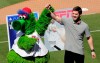 Bryce Harper stands with the Philadelphia Phillies mascot Phanatic before being introduced as a Phillies player during a news conference at the team's spring training baseball facility, Saturday, March 2, 2019, in Clearwater, Fla. Harper and the Phillies agreed to a $330 million, 13-year contract, the largest deal in baseball history. (AP Photo/Lynne Sladky)