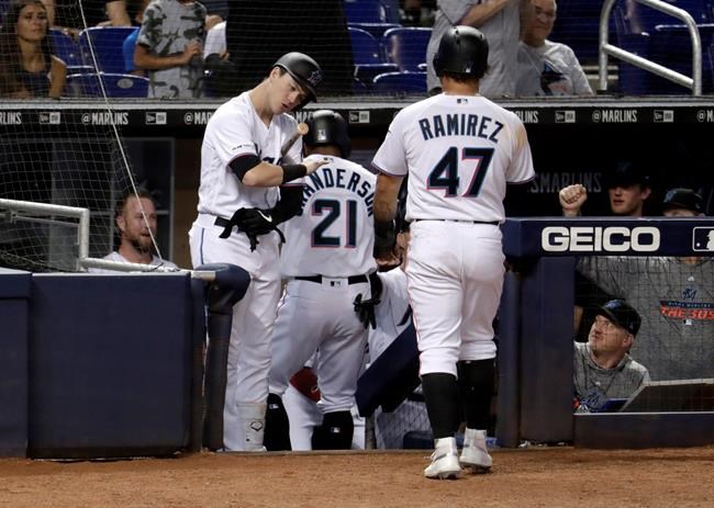 Miami Marlins' Brian Anderson, left, greets Curtis Granderson (21) and Harold Ramirez (47) after they scored during the second inning of a baseball game against the Arizona Diamondbacks, Monday, July 29, 2019, in Miami. (AP Photo/Lynne Sladky)
