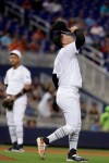 Miami Marlins starting pitcher Jordan Yamamoto (50) adjusts his cap during the fourth inning of a baseball game against the Philadelphia Phillies, Saturday, Aug. 24, 2019, in Miami. Philadelphia scored six runs in the inning. (AP Photo/Lynne Sladky)