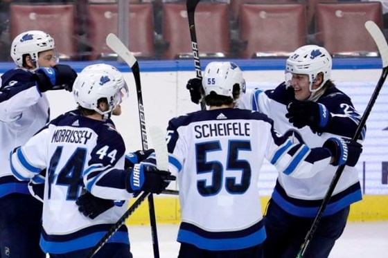 Winnipeg Jets right wing Patrik Laine, right, celebrates with defenseman Josh Morrissey (44) and center Mark Scheifele (55) after scoring a goal during the third period of an NHL hockey game against the Florida Panthers, Thursday, Nov. 14, 2019, in Sunrise, Fla. (AP Photo/Lynne Sladky)