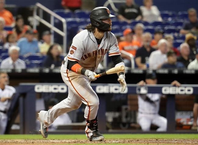 San Francisco Giants' Brandon Crawford watches after hitting a ground rule double to score two runs during the eighth inning of a baseball game against the Miami Marlins, Thursday, May 30, 2019, in Miami. (AP Photo/Lynne Sladky)